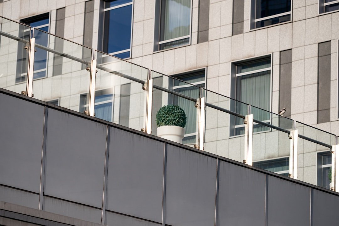 Modern building facade with glass balcony railing systems in India