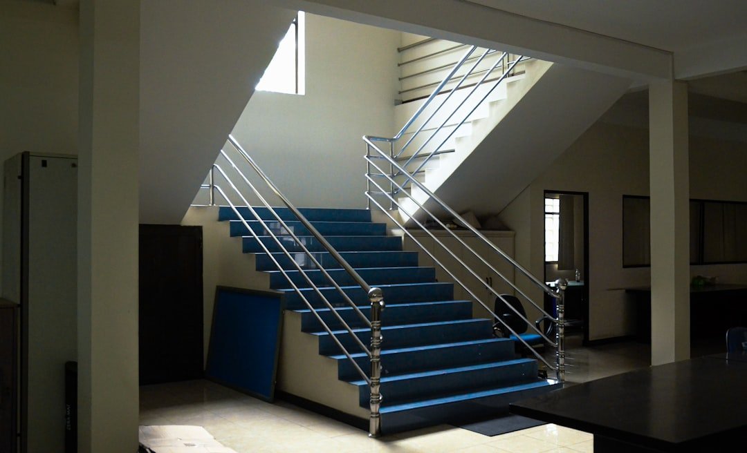Glass staircase railings in a modern commercial building interior in India