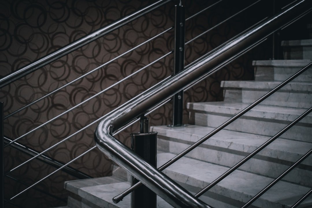 Stainless steel and glass staircase railing in a commercial building interior in India